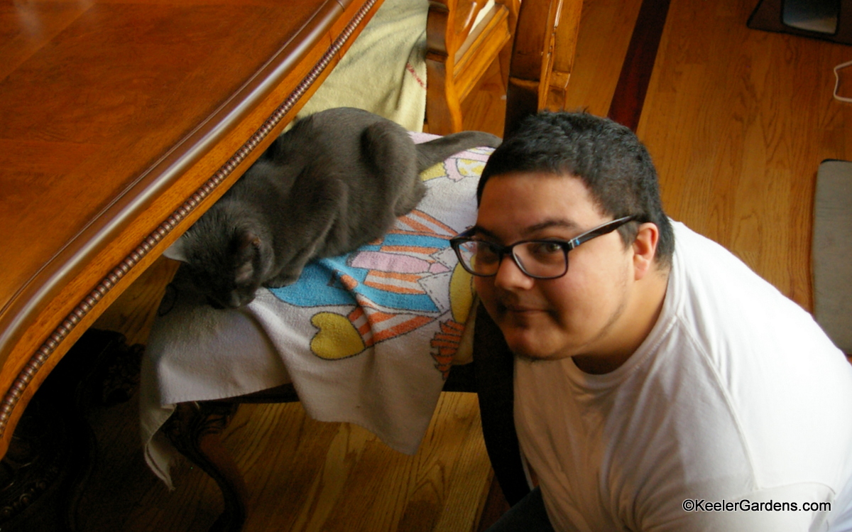 Frank, one of our Chi Tech Interns, takes a break to pose with Shadow, Shadow is a friendly Russian Blue that appreciates the extra attention.
